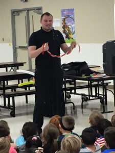 Man speaking and holding rope